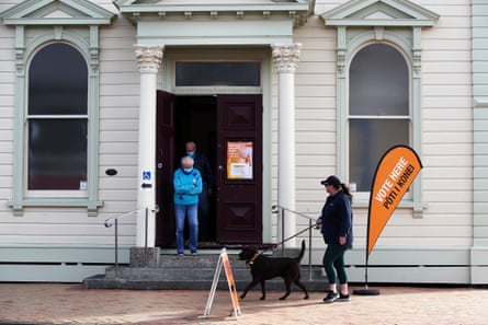 People walk past a voting centre in New Zealand.